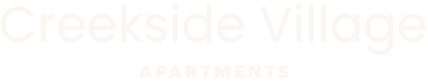 A sign that says Creekside Village Apartments.
