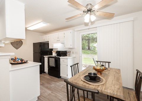 an open kitchen and dining room with a table and chairs