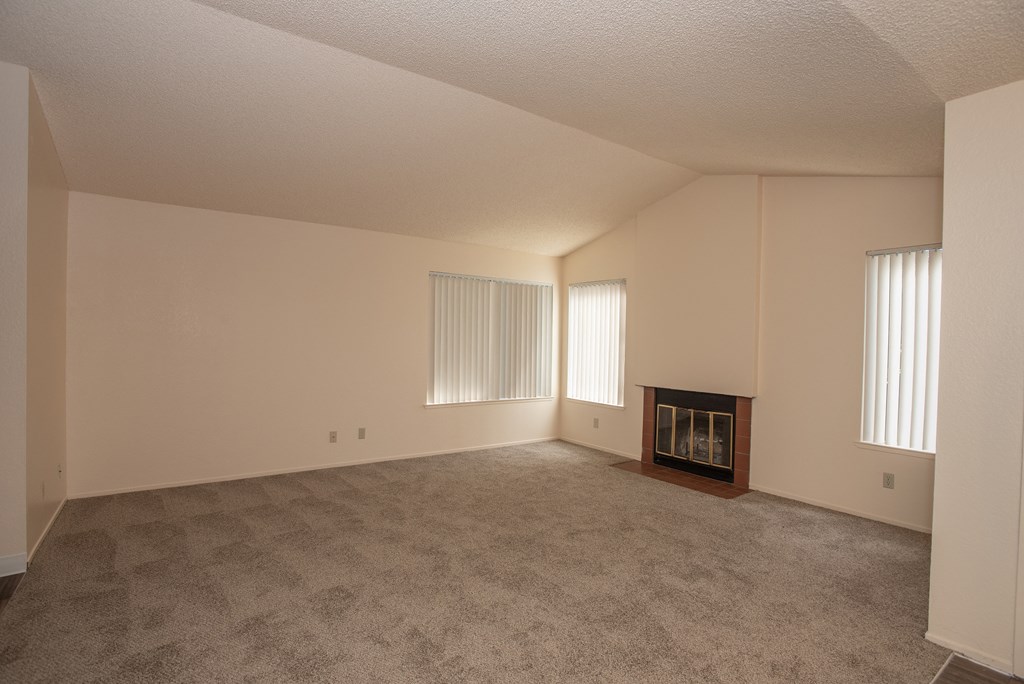 vacant living room with fireplace at Delta Pointe Apartments, Sacramento, California 95833