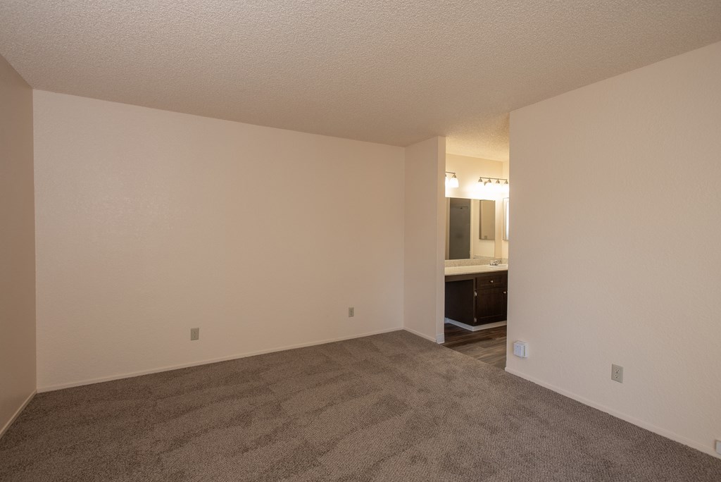 vacant primary bedroom and bathroom at Delta Pointe Apartments, CA 95833