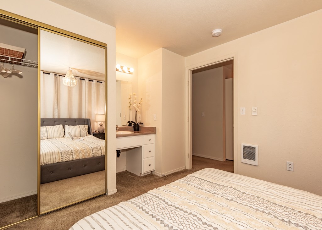 Hathaway Court model primary bedroom and vanity at Hathaway Court Apartments, Wilsonville