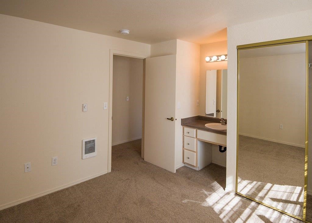 Primary Bedroom and Vanity at Hathaway Court Apartments, Wilsonville, OR