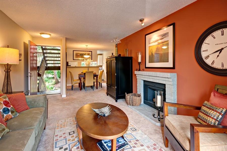 a living room with a fireplace and a table