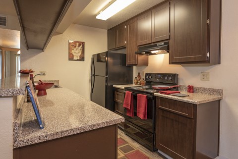 a kitchen with stainless steel appliances and granite counter tops