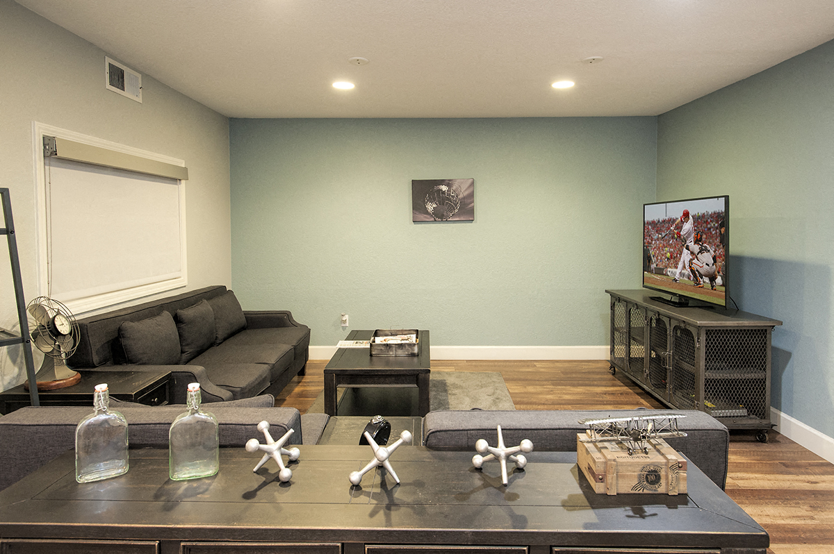a living room with a couch and a table and a tv