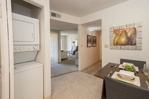 A modern kitchen with a dining table set for two.