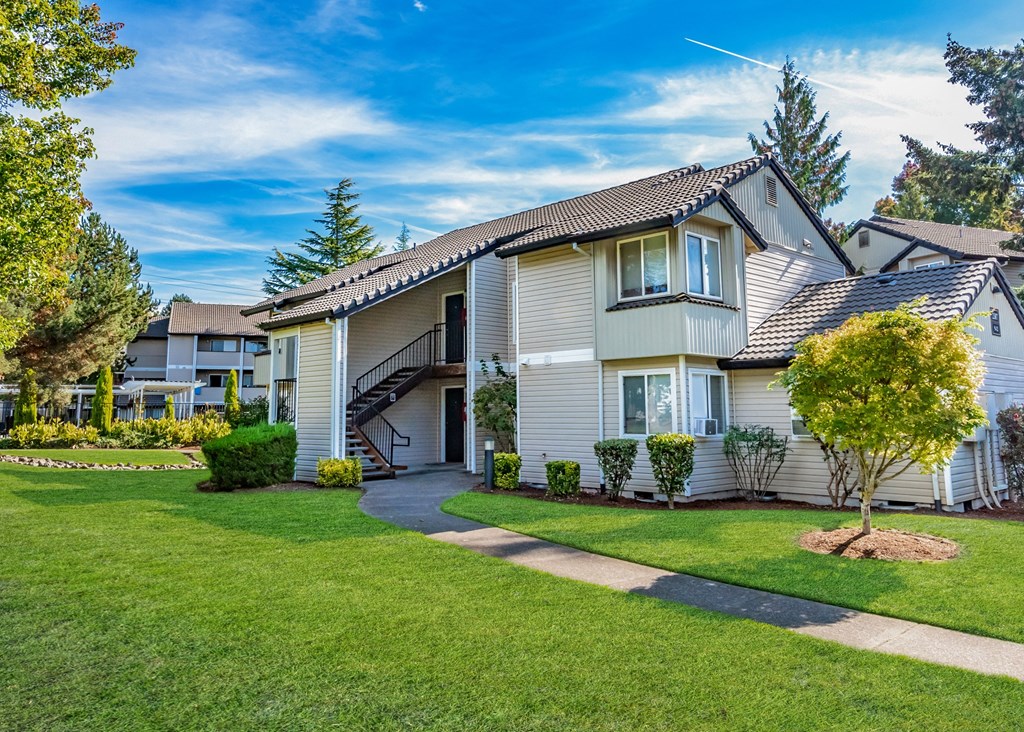 the front of a house with a yard and a sidewalk