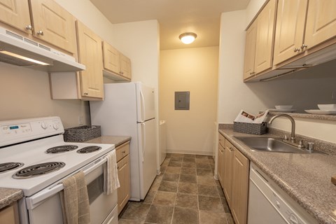 a kitchen with white appliances and granite counter tops and a white refrigerator