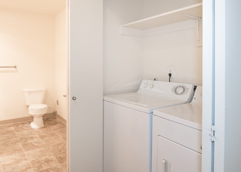 Stillwater vacant bathroom side view and full size washer and dryer in home laundry