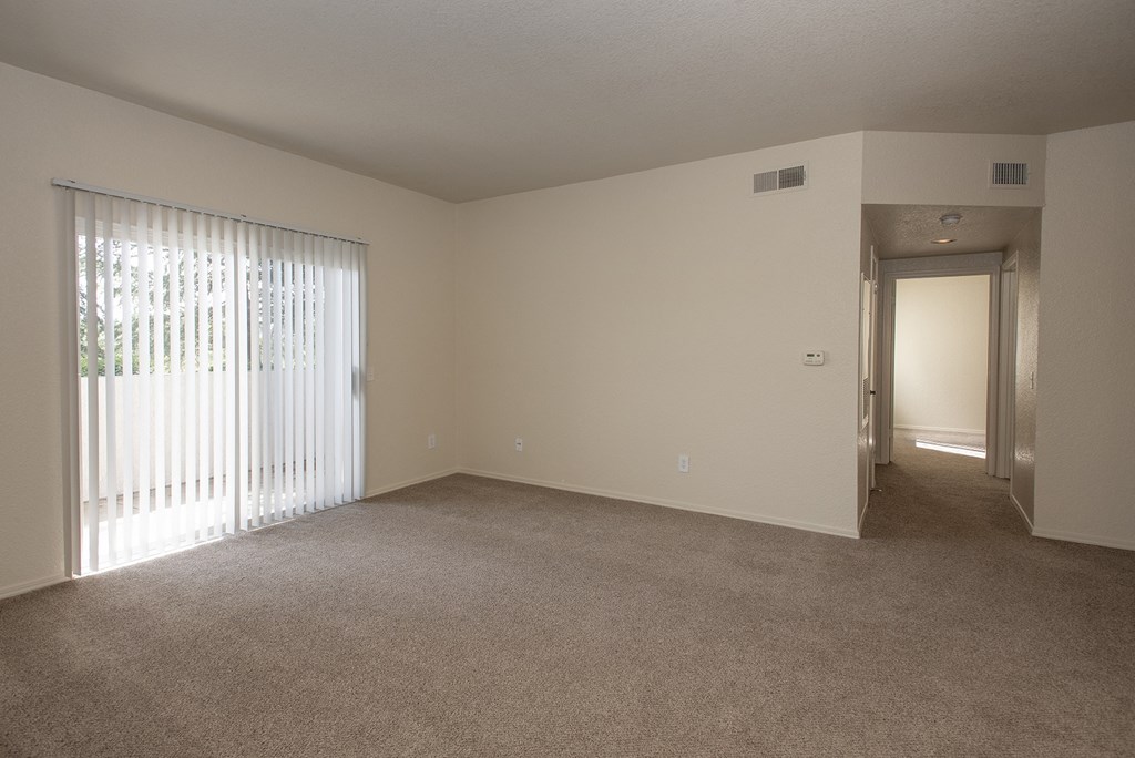 Vacant living room and patio sliding door at Sunset Summit, Rocklin, CA 95765