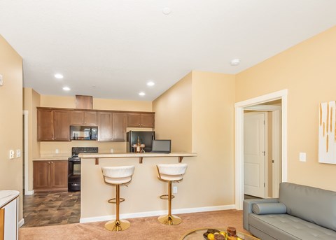 A kitchen with a bar area and a couch.