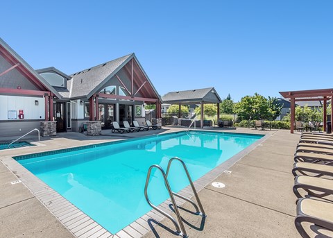 A large swimming pool with lounge chairs at The Landing Apartments and Townhomes, Oregon, 97045