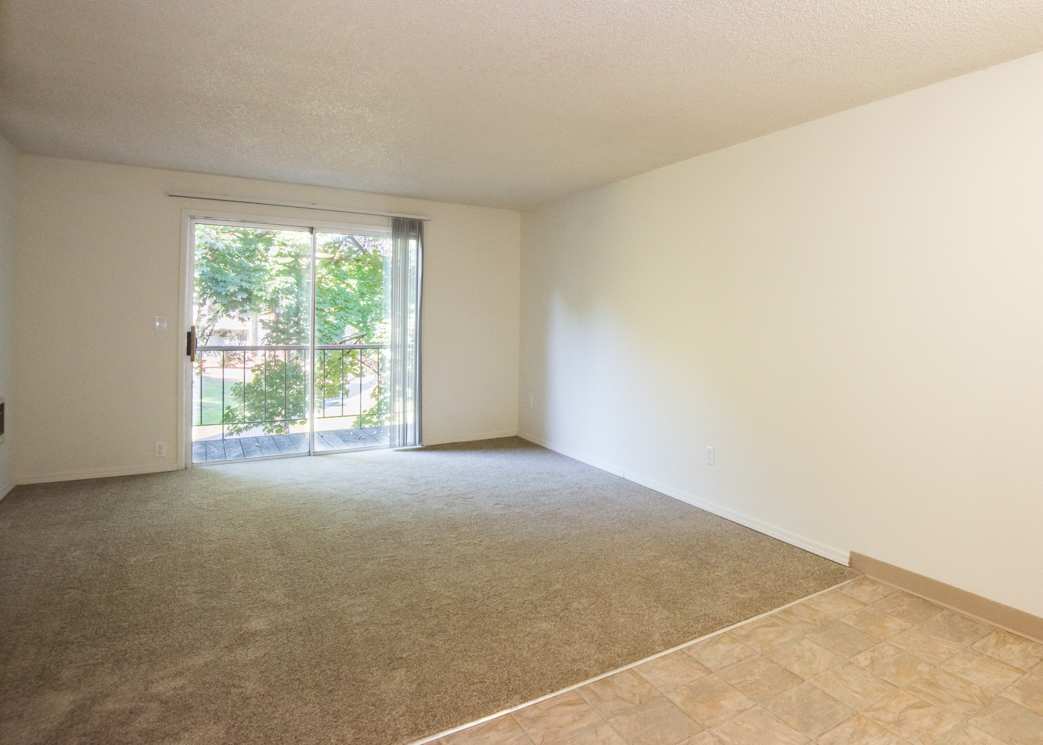 Vacant Apartment Living Room & Deck Sliding Door at Todd Village Apartments, Oregon, 97062