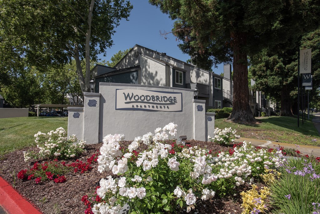 monument sign and flowers at Woodbridge Apartments, Sacramento, California 95833