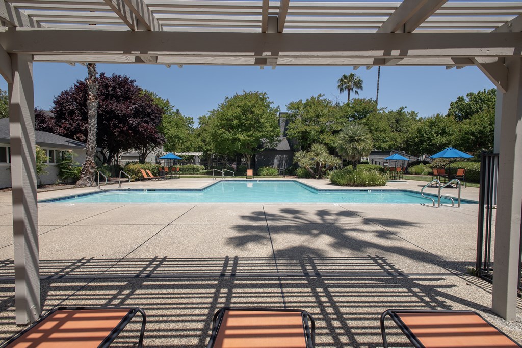swimming pool arbor and furniture at Woodbridge Apartments, California, 95833