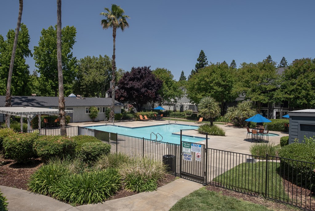 Woodbridge swimming pool fenced exterior at Woodbridge Apartments, Sacramento