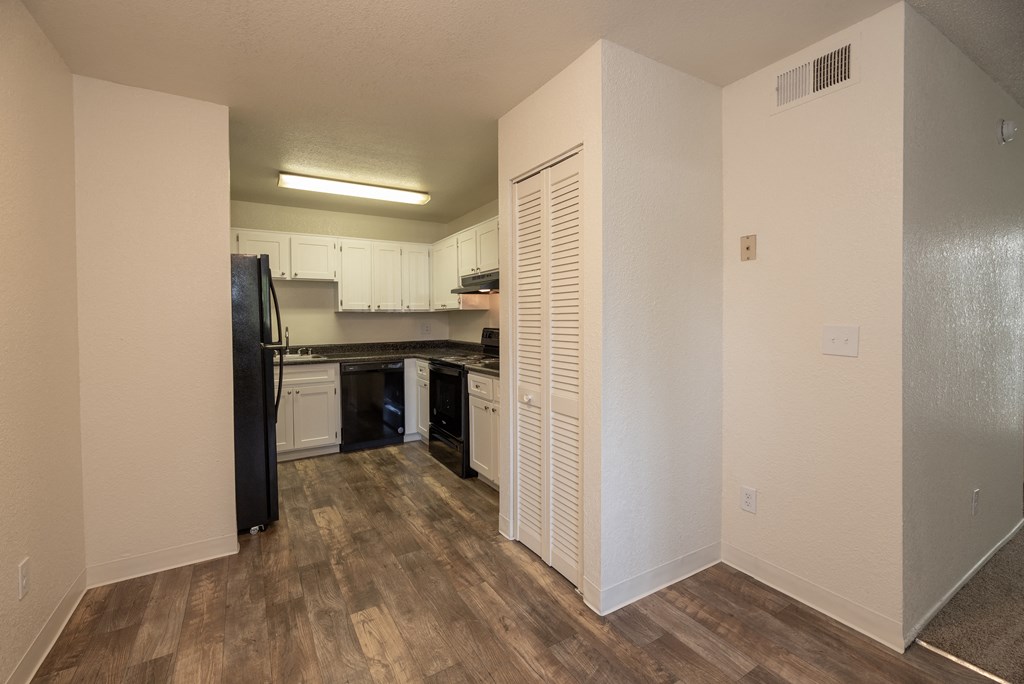 vacant 1x1 dining room to kitchen view at Woodbridge Apartments, Sacramento