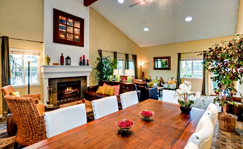 a living room with a wooden table and a fireplace