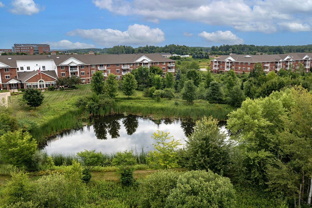 a view of a pond in front of a building