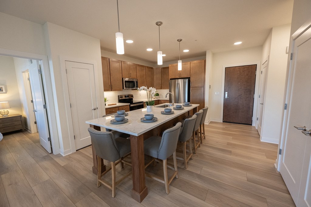a kitchen and dining room with a table and chairs