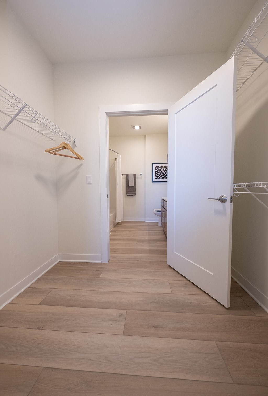 a hallway with a closet and a door to a bathroom