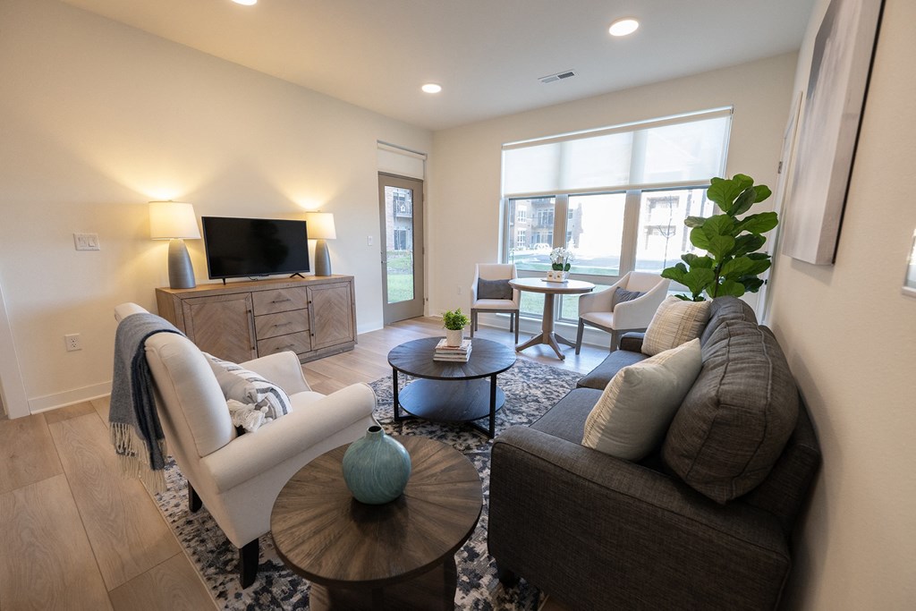 a living room with a couch and a table and a tv