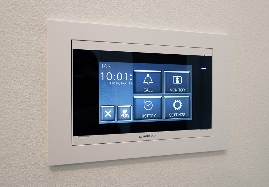 a touchscreen screen on a wall with icons on it