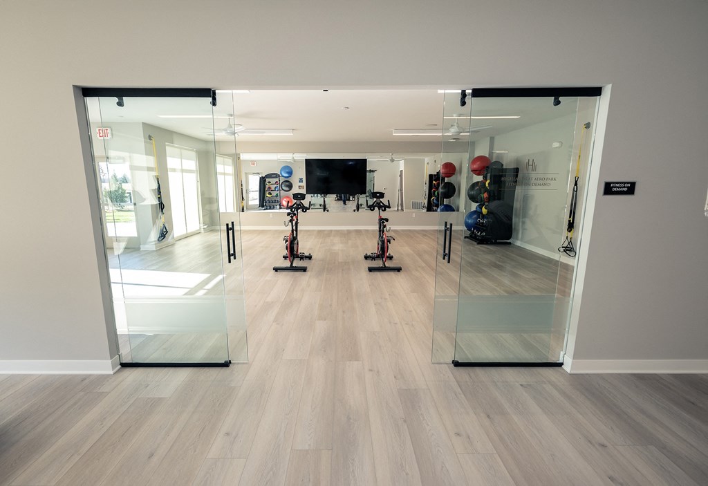 a view of the fitness room with mirrors and exercise equipment