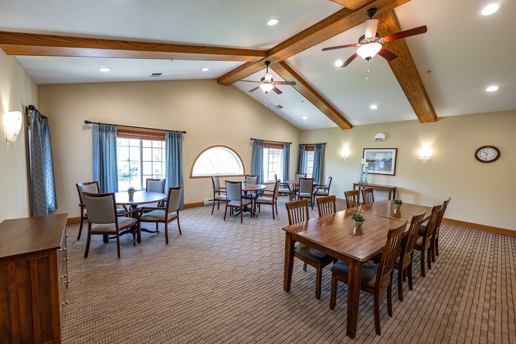 A large room with a dining table and chairs.
