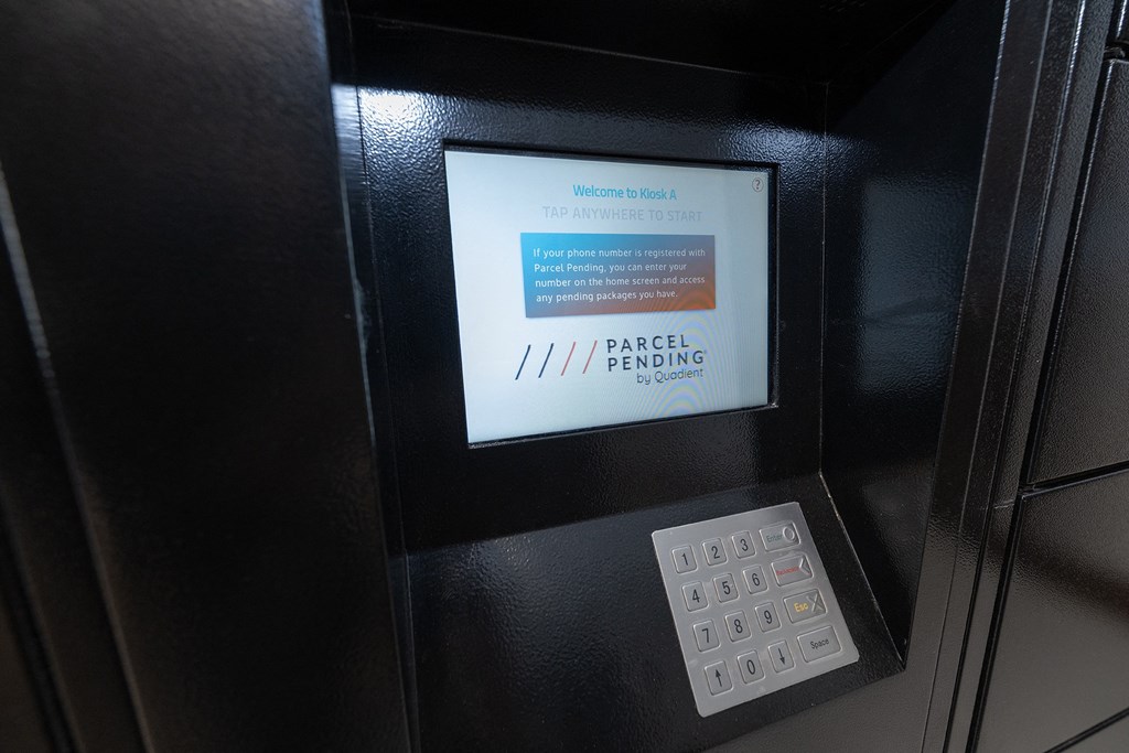 an atm machine with a screen and a remote control