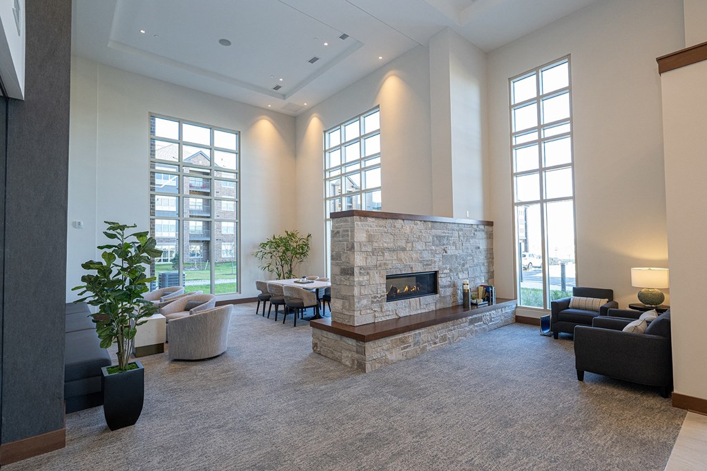 a large living room with a stone fireplace