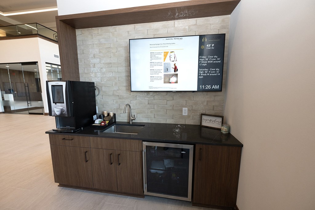 a counter with a sink and a tv on the wall