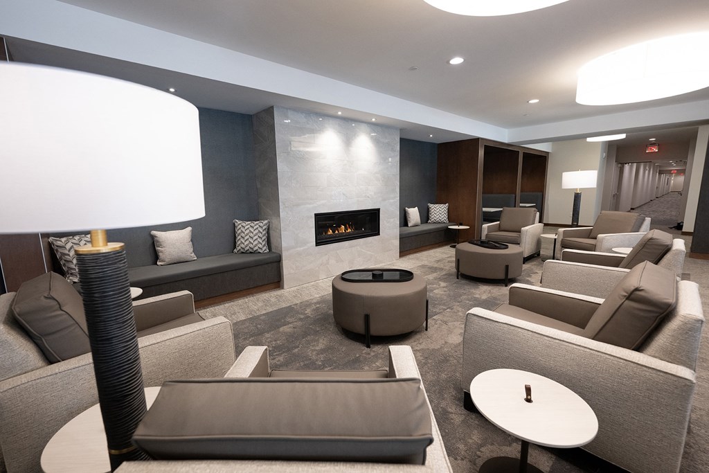 a living room with couches and chairs and a fireplace