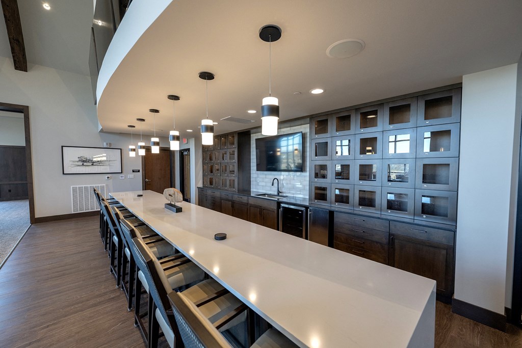 a large kitchen with a long white counter top