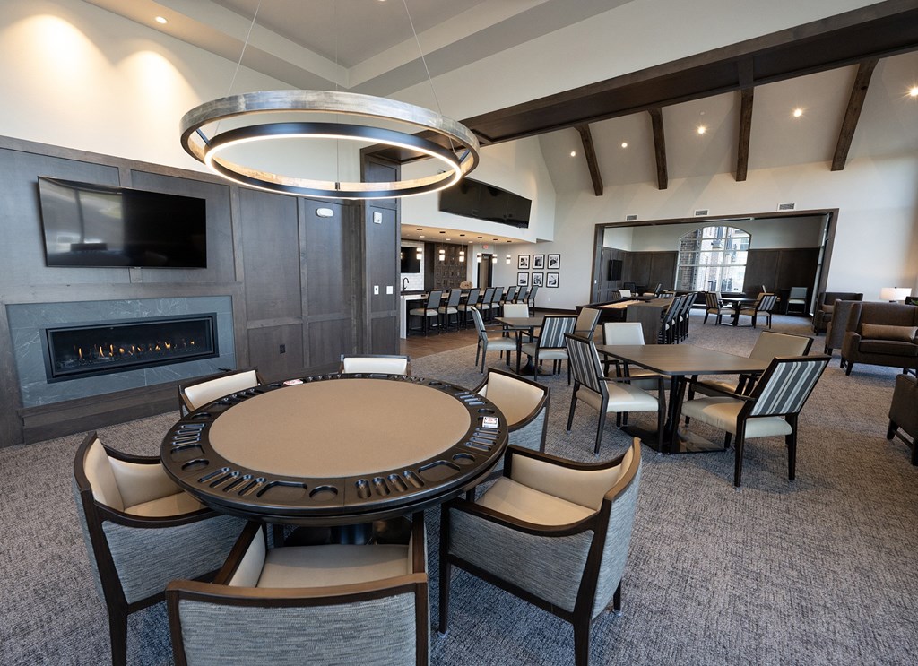 a large dining room with tables and chairs and a fireplace