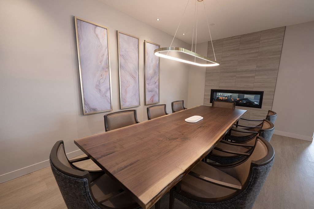 a conference room with a wooden table and chairs