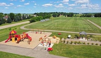 an aerial view of a playground with a field in the background