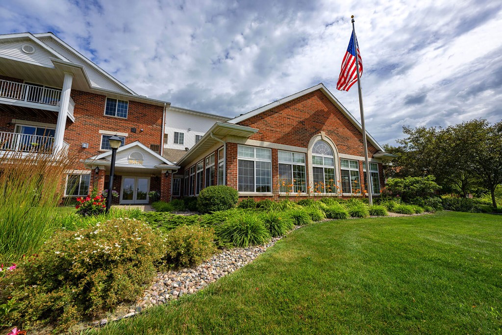 a large brick building with an american flag in front of it