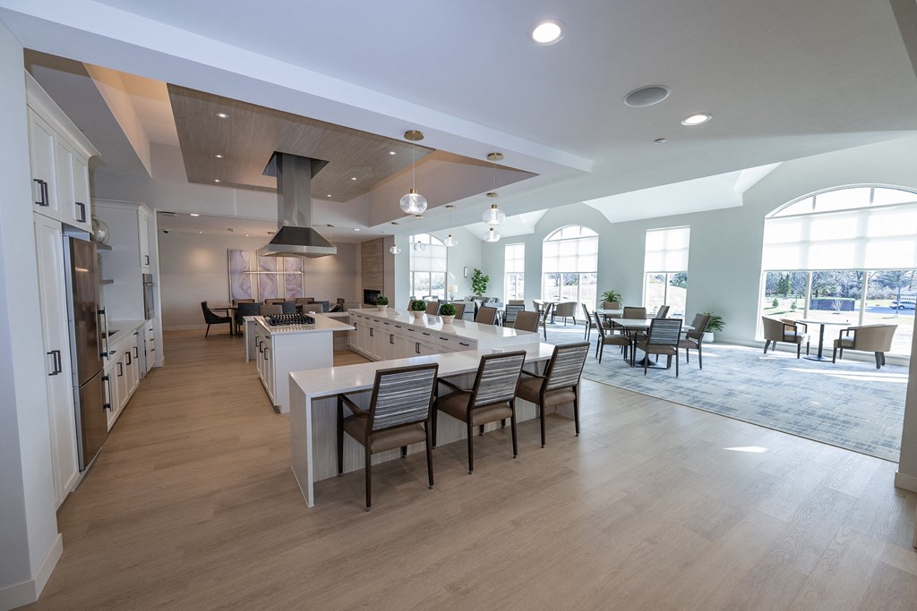 a large kitchen and dining room with a long table and chairs