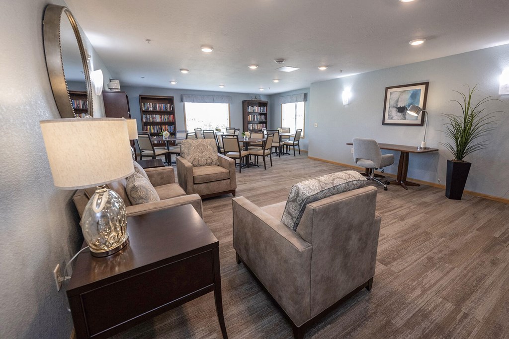 a resident clubhouse with couches chairs and tables