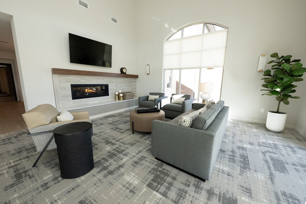 a living room with couches and chairs and a fireplace