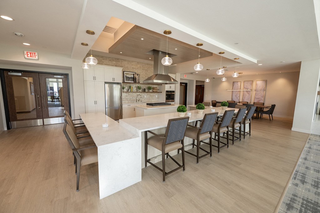 a large kitchen and dining room with a long table and chairs