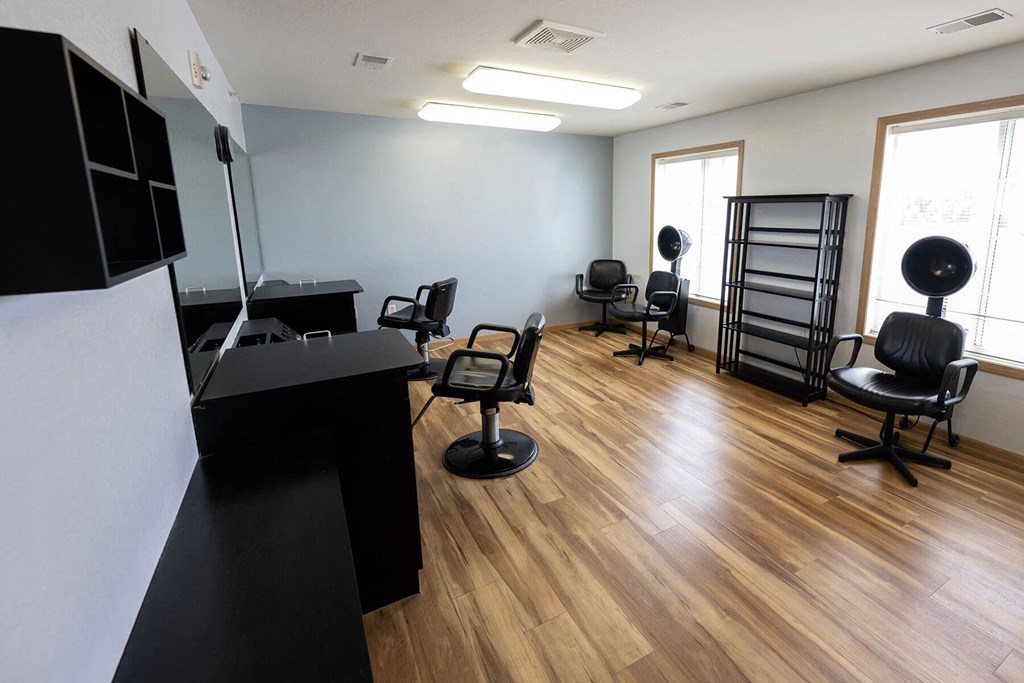 a salon room with chairs and a desk