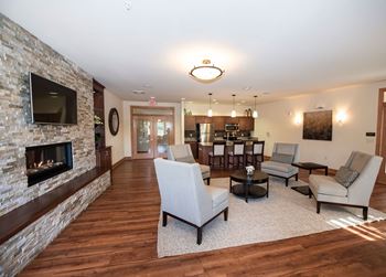 a living room with a fireplace and a table with chairs