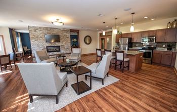 a living room and kitchen with chairs and a table