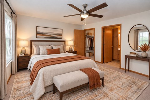 A bedroom with two beds and a ceiling fan.