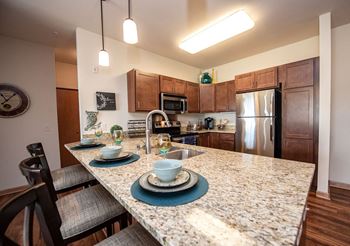a kitchen with granite counter tops and stainless steel appliances