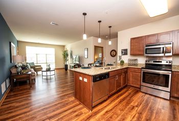 a kitchen and living room with wood flooring and