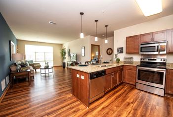 a kitchen and living room with wood flooring and