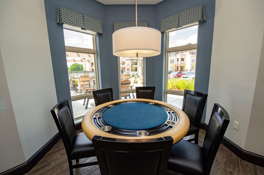 a dining room with a round table and chairs
